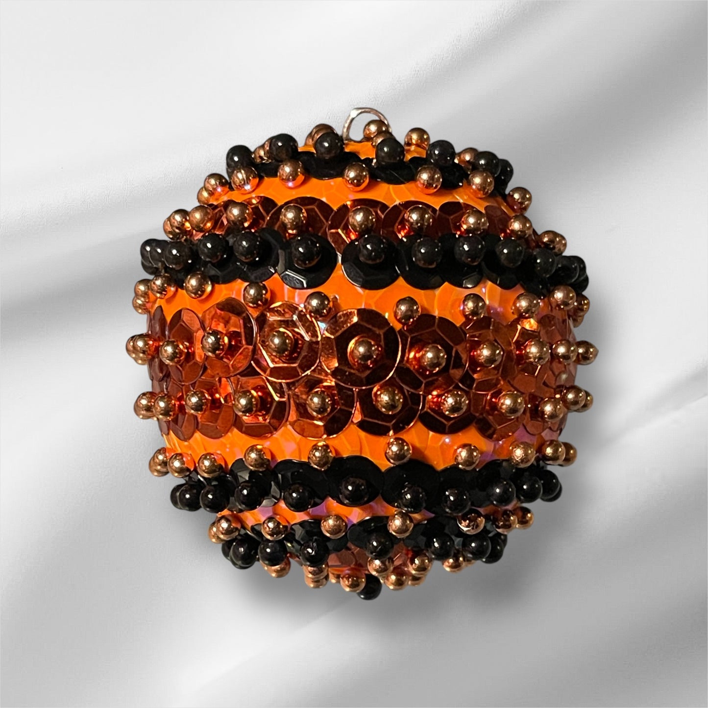 Florescent and metallic orange with black sequin ornament 2.5”